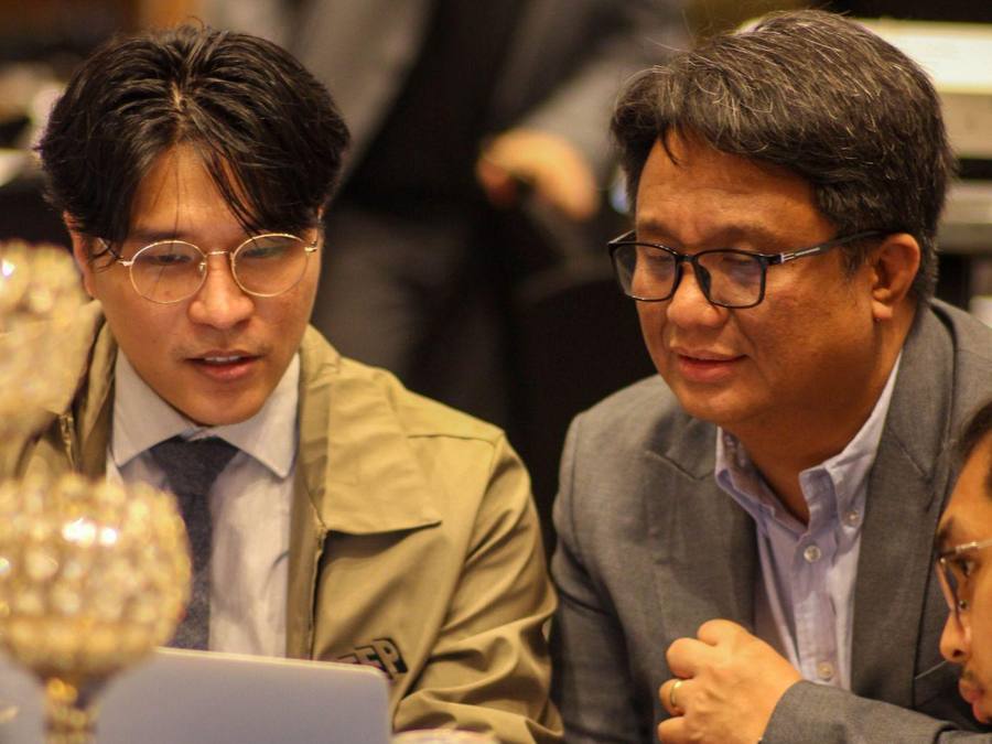 Mentor and participant reviewing work on a laptop